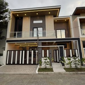 Front view of furnished house for sale in Angeles City near Clark with high ceiling living area and 2-car carport